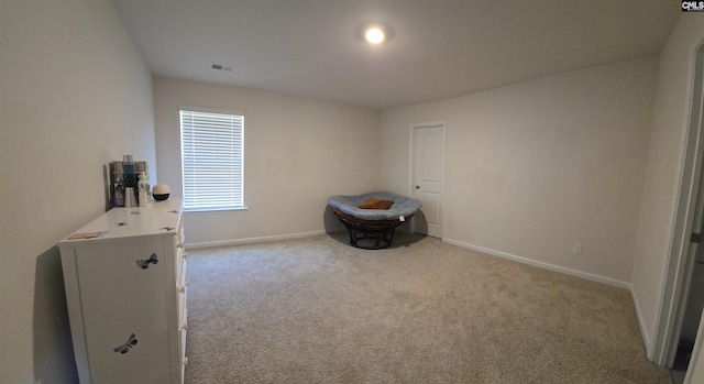 bedroom featuring light carpet, visible vents, and baseboards