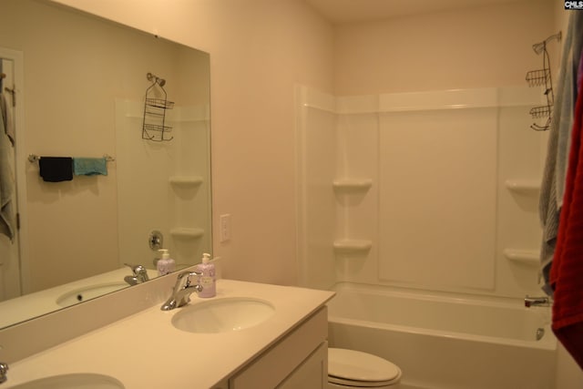 bathroom featuring a sink, toilet, and double vanity
