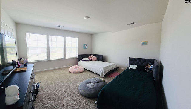 carpeted bedroom featuring baseboards and visible vents