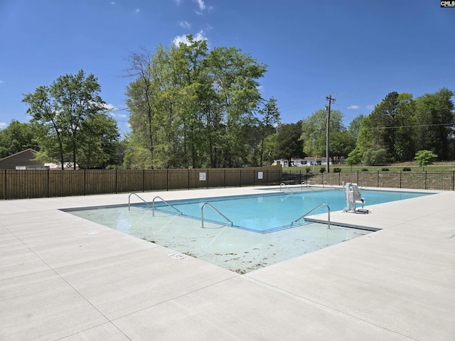 community pool featuring a patio area and fence