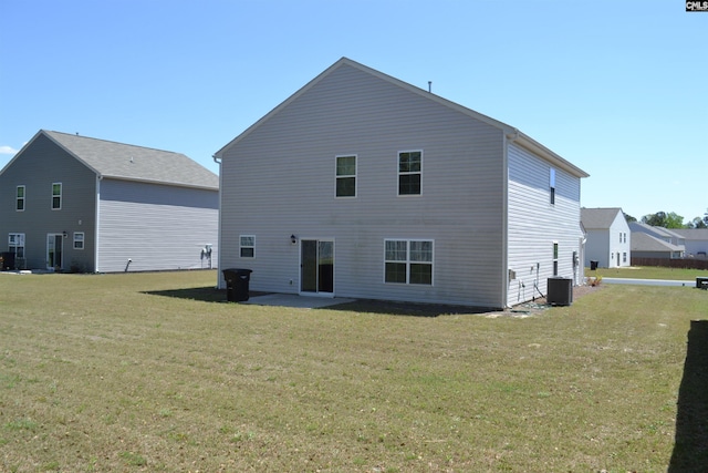 back of house featuring a patio and a yard