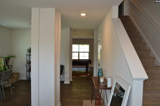 hallway with dark wood-style flooring, baseboards, recessed lighting, and stairs