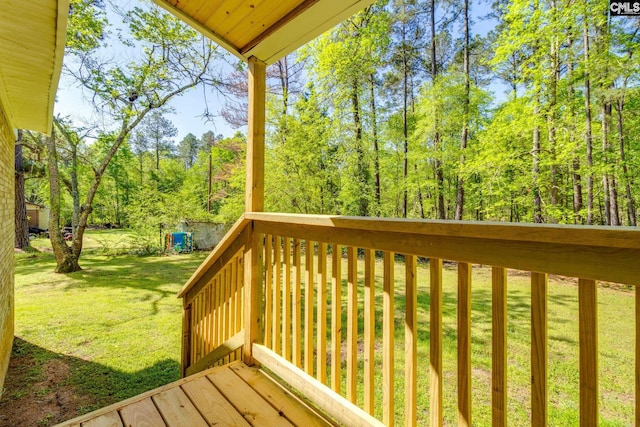 wooden terrace featuring a yard