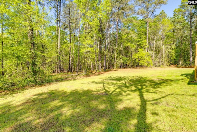 view of yard with a view of trees