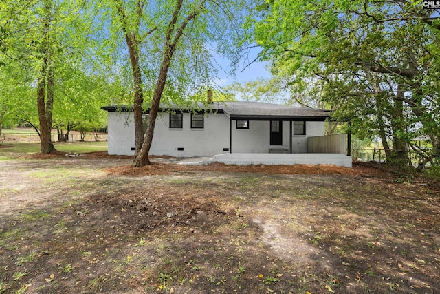 back of property featuring crawl space