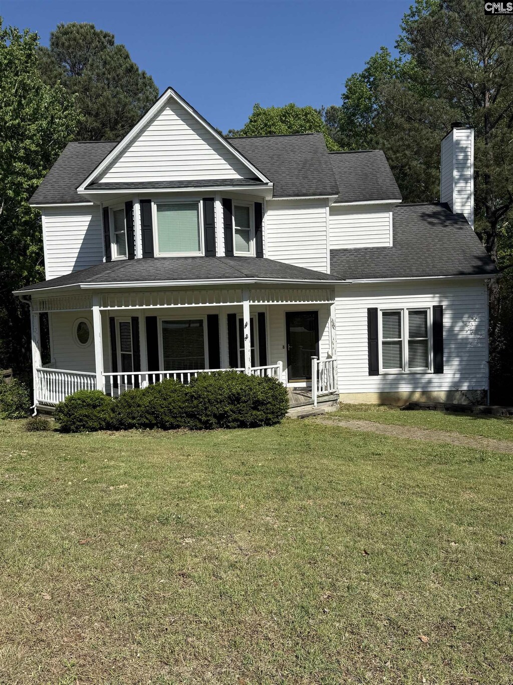 220 Alton Pl, Columbia, SC 29210 - farmhouse inspired home featuring a shingled roof, a chimney, covered porch, and a front lawn