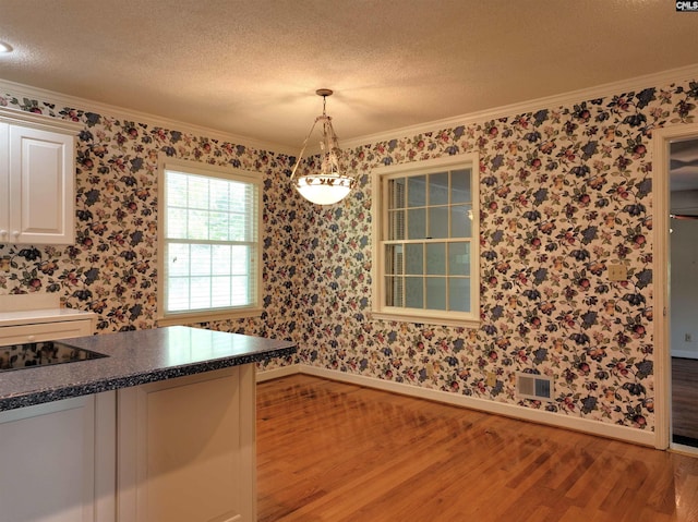 325 Third Ave, Lexington, SC 29072 - kitchen with baseboards, crown molding, light wood finished floors, white cabinetry, and pendant lighting