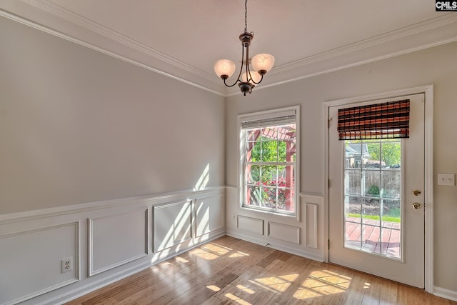 113 Wild Spring Rd, Lexington, SC 29072 - unfurnished dining area featuring a notable chandelier, crown molding, a wainscoted wall, a decorative wall, and light wood finished floors