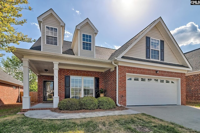 113 Wild Spring Rd, Lexington, SC 29072 - view of front of house with driveway, brick siding, a garage, a shingled roof, and covered porch