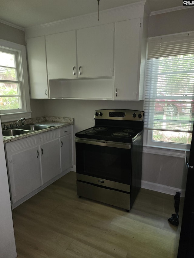 303 Southview Dr, Laurens, SC 29360 - kitchen featuring electric range, white cabinetry, ornamental molding, a sink, and light wood finished floors