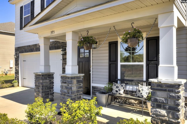 entrance to property with driveway, a porch, and a garage