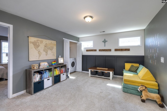 playroom featuring a wealth of natural light, washer / clothes dryer, and carpet flooring