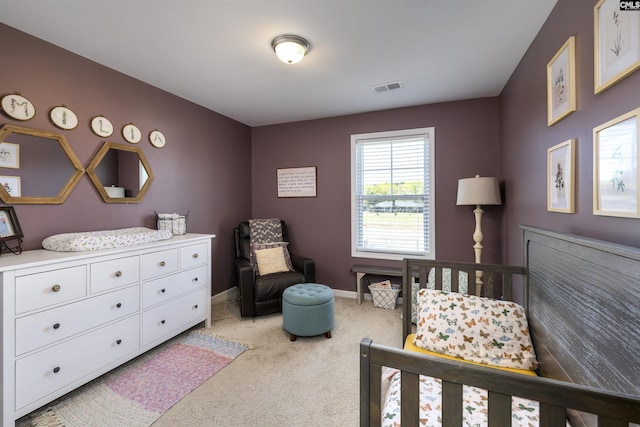 bedroom featuring visible vents, baseboards, and light carpet