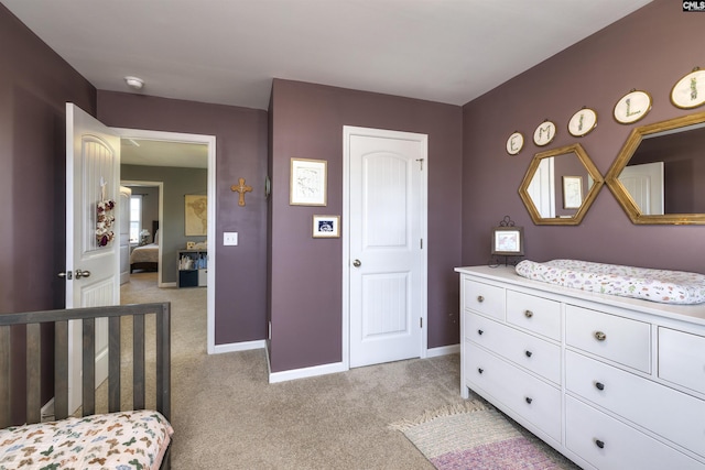 bedroom with baseboards and light carpet