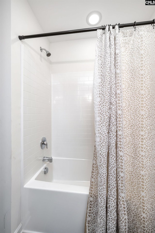 bathroom with shower / bathtub combination with curtain