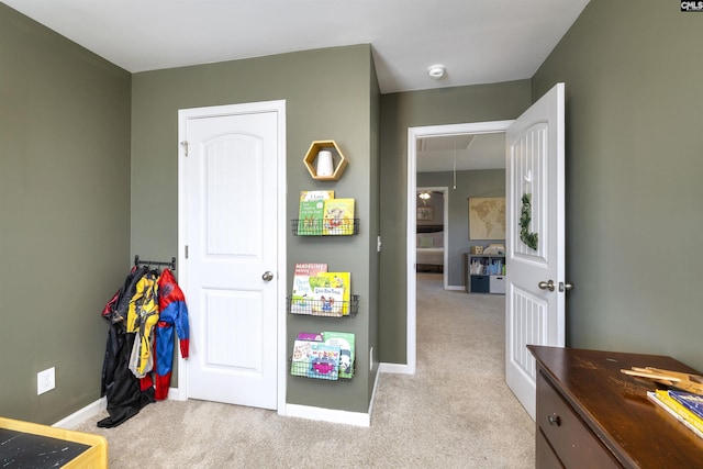recreation room featuring baseboards and carpet