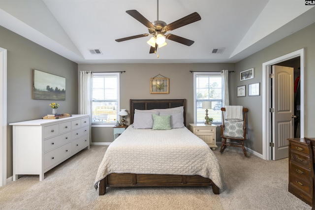 bedroom with visible vents, multiple windows, light carpet, and lofted ceiling