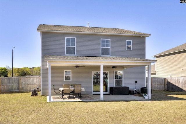 rear view of house featuring a patio, a fenced backyard, a ceiling fan, and a lawn