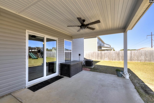 view of patio with cooling unit, fence, a playground, and ceiling fan