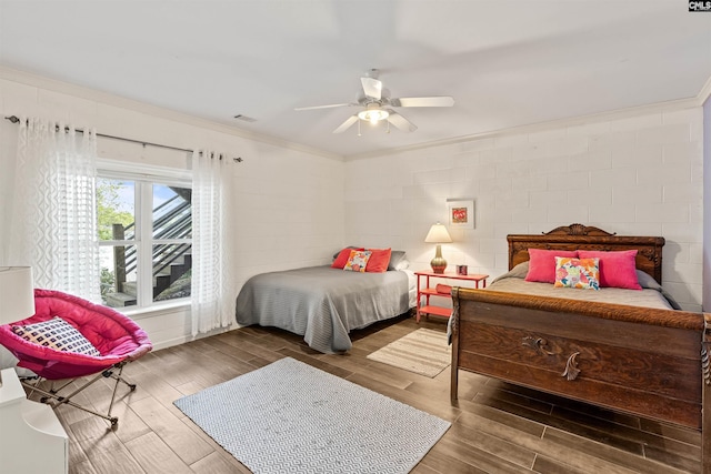 1724 Gold Nugget Pt, Prosperity, SC 29127 - bedroom with concrete block wall, crown molding, a ceiling fan, and wood finished floors