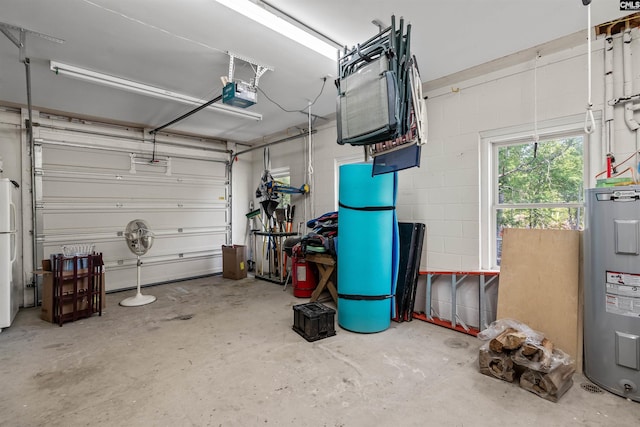 1724 Gold Nugget Pt, Prosperity, SC 29127 - garage with electric water heater, freestanding refrigerator, and a garage door opener