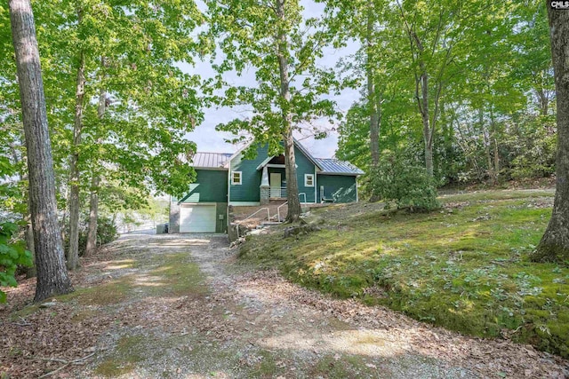 1724 Gold Nugget Pt, Prosperity, SC 29127 - exterior space with dirt driveway, an attached garage, metal roof, and a standing seam roof