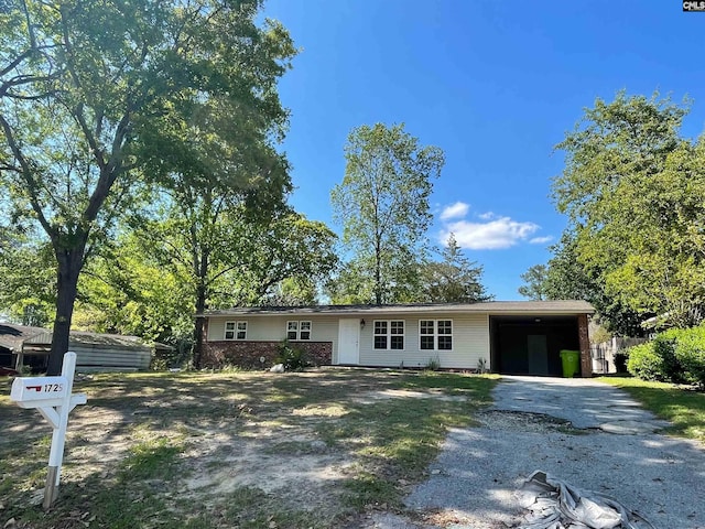 ranch-style home with driveway and an attached carport