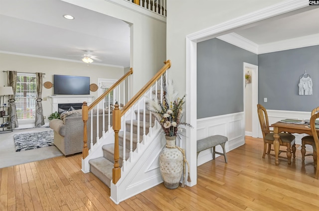 304 Oakhurst Pl, Blythewood, SC 29016 - stairs featuring wood-type flooring, wainscoting, a ceiling fan, and ornamental molding