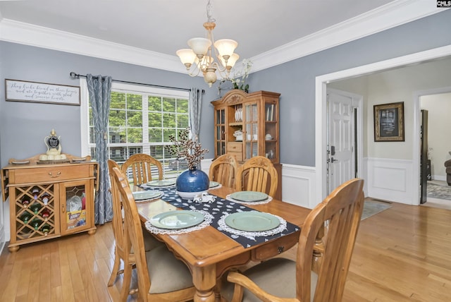 304 Oakhurst Pl, Blythewood, SC 29016 - dining space with light wood-style floors, a notable chandelier, crown molding, and wainscoting