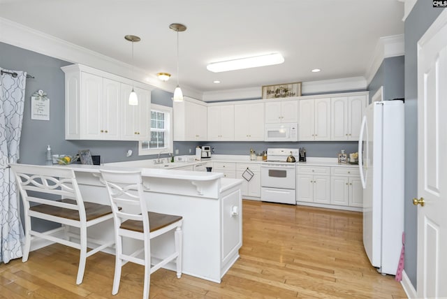 304 Oakhurst Pl, Blythewood, SC 29016 - kitchen featuring white cabinets, white appliances, crown molding, and a peninsula