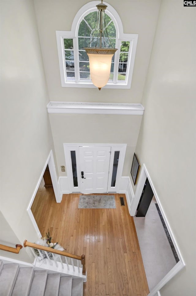 304 Oakhurst Pl, Blythewood, SC 29016 - entrance foyer with stairs, light wood-style flooring, a high ceiling, and visible vents