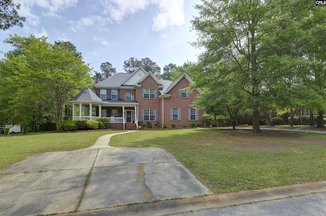 304 Oakhurst Pl, Blythewood, SC 29016 - view of front facade with covered porch, a front lawn, and brick siding