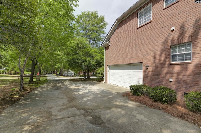 304 Oakhurst Pl, Blythewood, SC 29016 - view of side of home with brick siding, an attached garage, and concrete driveway