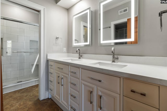 bathroom with double vanity, visible vents, a sink, and a stall shower