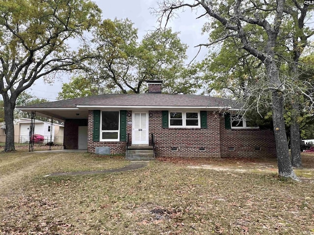 ranch-style home featuring a carport, a chimney, driveway, crawl space, and brick siding