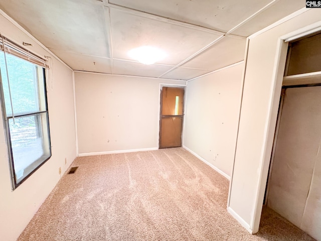 unfurnished bedroom featuring visible vents, baseboards, and carpet floors
