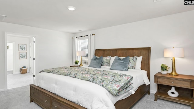 bedroom featuring visible vents, baseboards, and light carpet