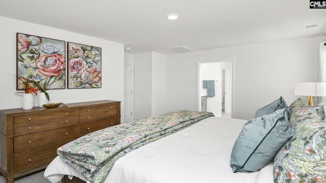 bedroom featuring ensuite bath and visible vents