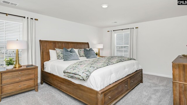 bedroom with light colored carpet, baseboards, and visible vents