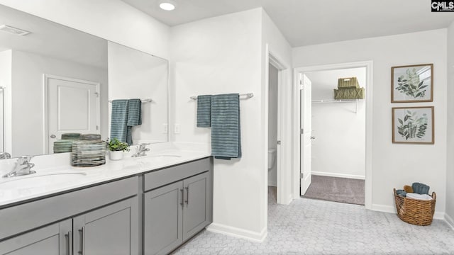 bathroom featuring a sink, visible vents, and baseboards