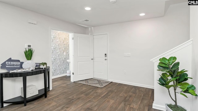 entrance foyer featuring dark wood-style flooring, baseboards, visible vents, and recessed lighting
