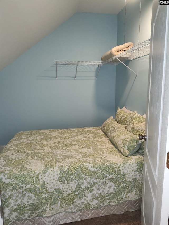 carpeted bedroom featuring lofted ceiling