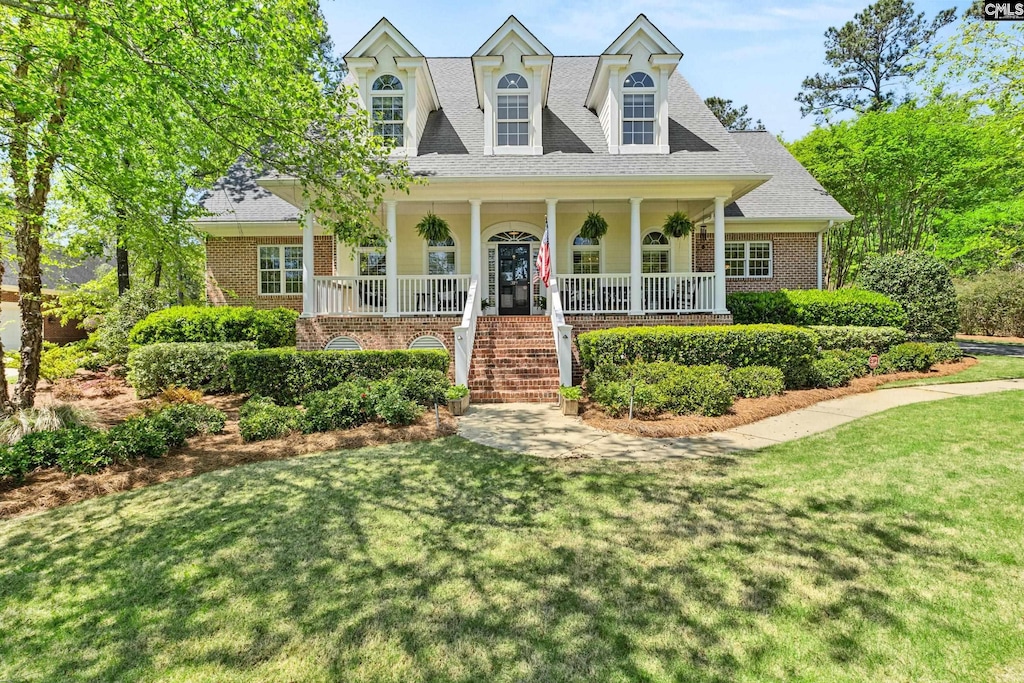 319 Old Course Loop, Blythewood, SC 29016 - cape cod home featuring stairway, brick siding, a porch, and a front lawn