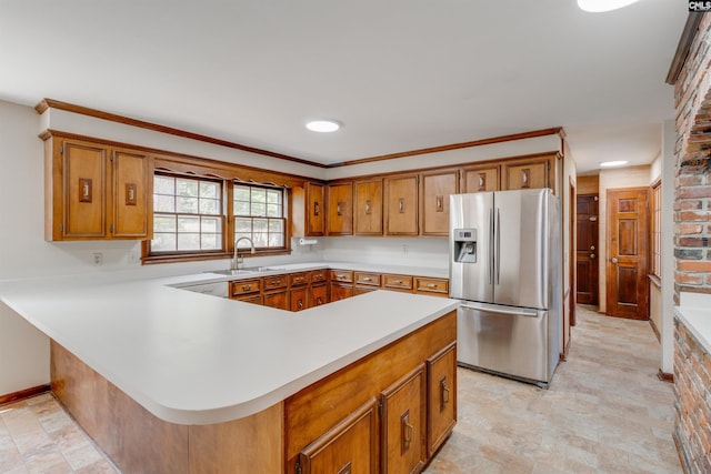 1605 Quail Lake Dr, West Columbia, SC 29169 - kitchen featuring stainless steel fridge with ice dispenser, light countertops, brown cabinetry, and a sink