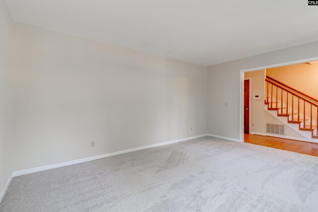 1605 Quail Lake Dr, West Columbia, SC 29169 - carpeted empty room with visible vents, baseboards, and stairway