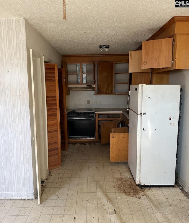 1115 Robinson St, Hartsville, SC 29550 - kitchen featuring open shelves, freestanding refrigerator, wall oven, a textured ceiling, and light floors