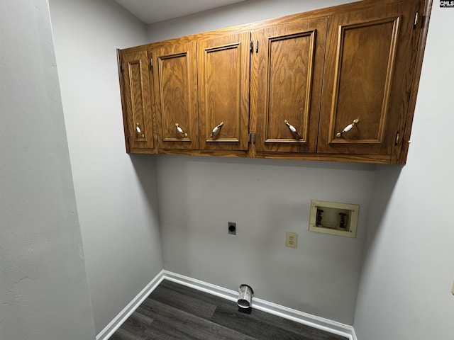 clothes washing area featuring hookup for a washing machine, electric dryer hookup, dark wood-style flooring, baseboards, and cabinet space