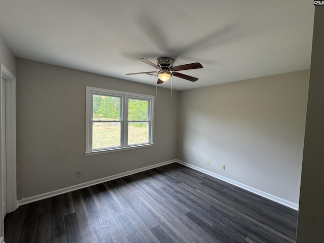 empty room with dark wood-type flooring, baseboards, and ceiling fan