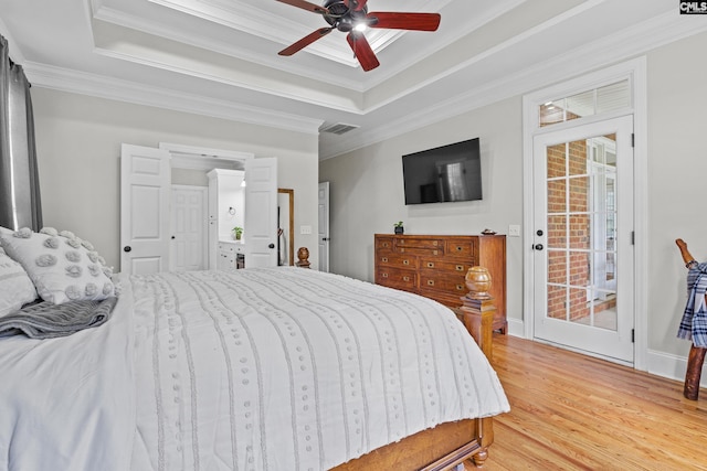 124 Loch Levin Ln, Lexington, SC 29072 - bedroom featuring visible vents, a tray ceiling, ornamental molding, and light wood-style flooring