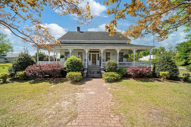 131 Pine St, Salley, SC 29137 - country-style home with a chimney, a front lawn, covered porch, and roof with shingles